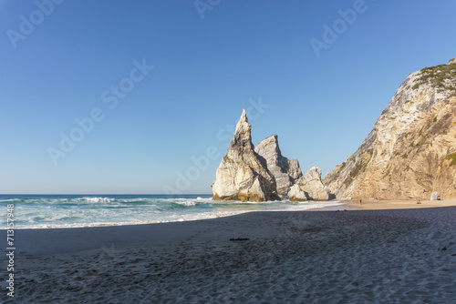 Praia da Ursa beach with rock formation on a sunny day, in Sintra, Lisbon, Portugal