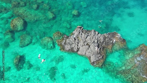 Aerial of people swimming in Waimea Bay photo