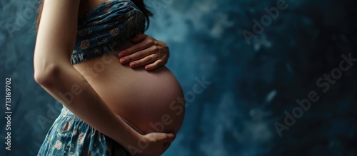 excess weight on the belly in the hands of a young woman after giving birth. Copy space image. Place for adding text photo
