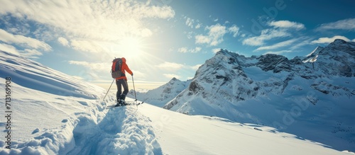 Mountaineer backcountry ski walking ski alpinist in the mountains Ski touring in alpine landscape with snowy trees Adventure winter sport. Copy space image. Place for adding text photo