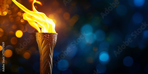 torch with Olympic flame on a dark background, copyspace photo