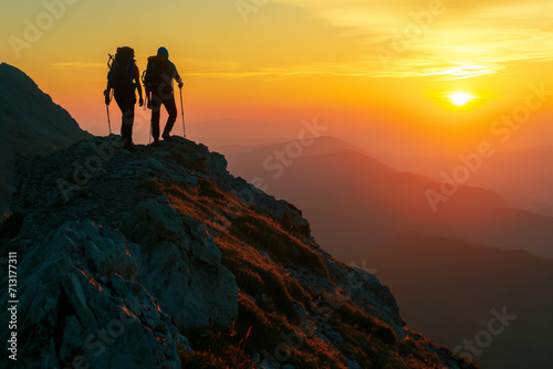 Couple Hiking Towards Sunset on Mountain