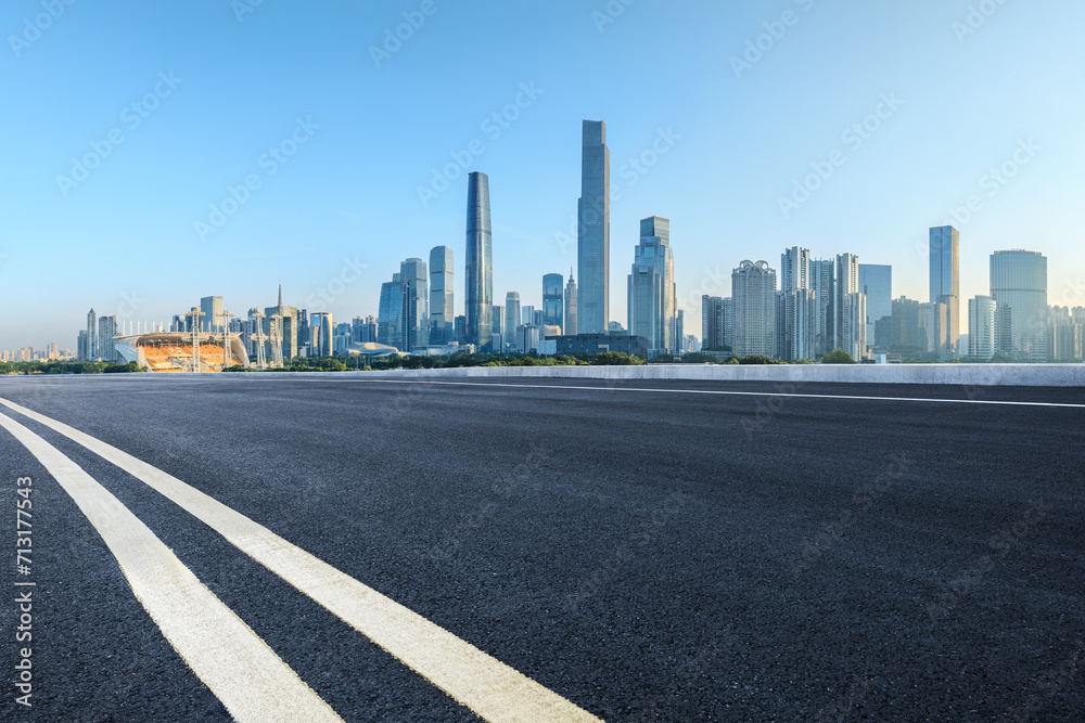 Empty asphalt and city buildings skyline