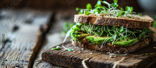 healthy rye sandwich with avocado cucumber alfalfa sprouts. Copy space image. Place for adding text