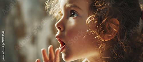 A cute child with a speech therapist is taught to pronounce the letters words and sounds correctly. Copy space image. Place for adding text photo