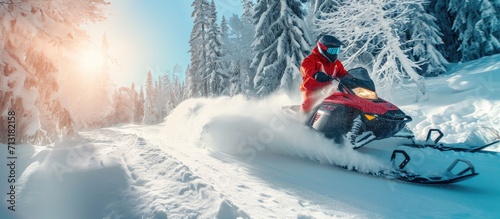 Snowmobile Jump Extreme Snowmobile Ride Racing a bright suit and a snow motorcycle Winter Recreation high resolution and photo quality. Copy space image. Place for adding text photo