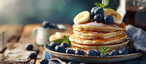 Homemade pancakes with syrup and berries Morning and breakfast pancakes with banana and blueberries. Copy space image. Place for adding text photo