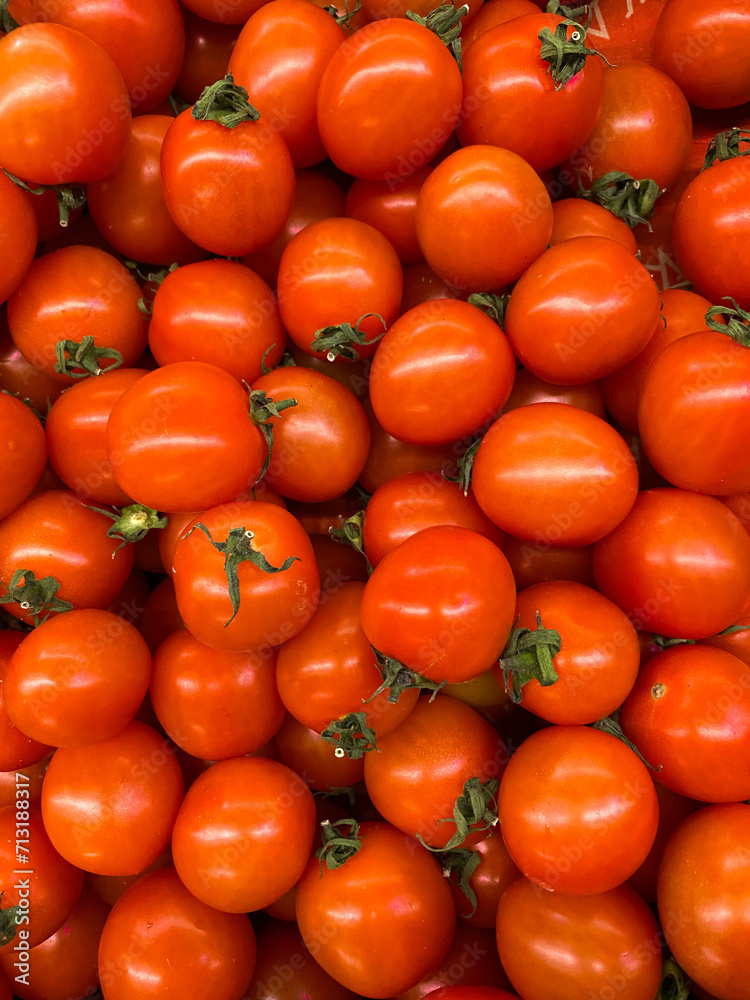 Set of small tomatoes top view. Delivery of vegetables, sale of vegetables in markets and supermarkets. Red vegetable background