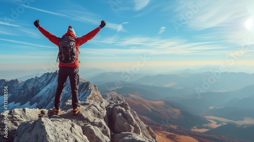 Strong and confident man standing on to a mountain. Fit active lifestyle concept. Positive man celebrating on mountain top, with arms raised up, Goal, successful, achievement  © Sweetrose official 