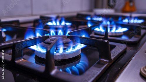 Photograph of a home stove gas burner with blue and yellow flames. Gas cooking with stove.
