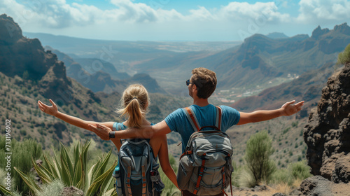 Couple hikers success and trust in mountains, accomplish with arms up outstretched. Young man and woman looking at beautiful inspirational landscape view, Islands. Young confident 