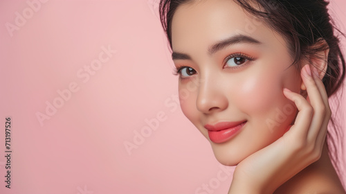 Portrait of beautiful happy Asian woman model touching healthy facial skin on clean background, cosmetics concept with copy space