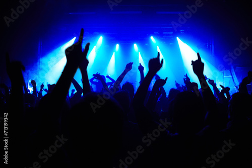 Nightclub, party and audience with hands or lights for music, concert or rave festival with spotlight and dancing. Disco, psychedelic event and performance with entertainment, crowd and mock up space