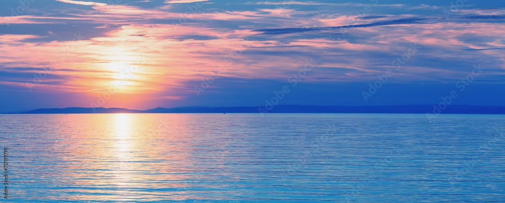 Seascape early in the morning. Sunrise over the sea. Natural landscape. Horizontal banner