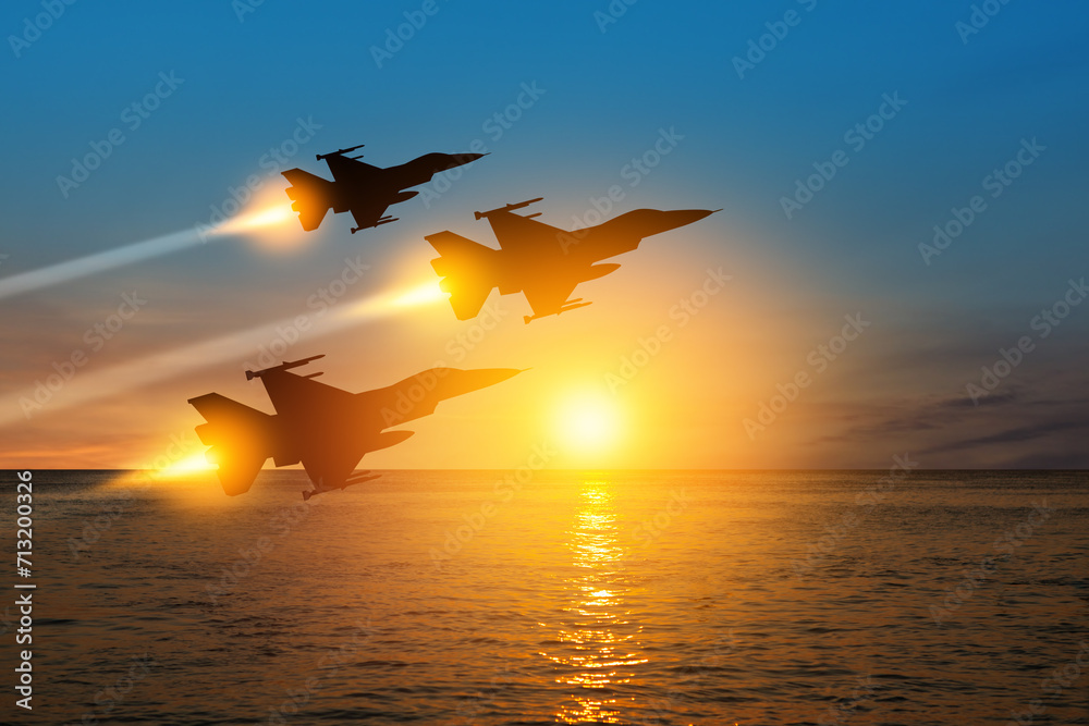 Air Force Day. Aircraft silhouettes on background of sunset on the sea. - obrazy, fototapety, plakaty 