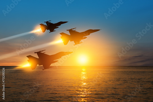 Air Force Day. Aircraft silhouettes on background of sunset on the sea. photo
