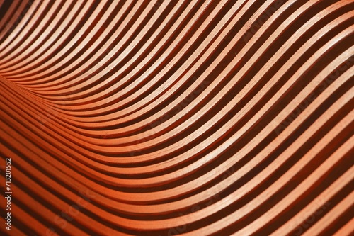 Brown wooden curved slats. Bench element, architectural exterior design of a building. Abstract background.