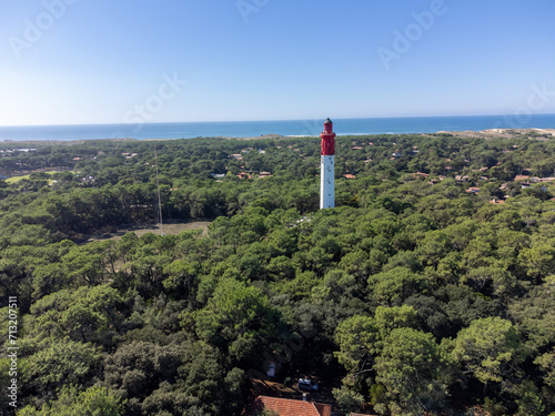 Aerial view on Arcachon Bay with many fisherman's boats and oysters farms and red lighthouse Le Phare du Cap Ferret, Cap Ferret peninsula, France, southwest of Bordeaux, France's Atlantic coastline photo