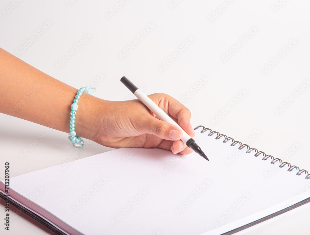 School supplies, teenager's hand drawing with markers, white background, selective focus. School supplies, teenager's hand drawing with markers, white background, selective focus.