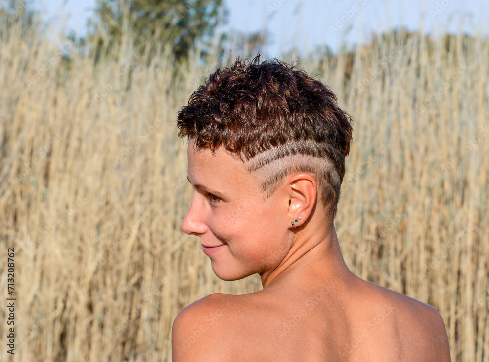 young girl with tanned skin with an undercut haircut and shaved strips on her head young girl with tanned skin with an undercut haircut and shaved strips on her head