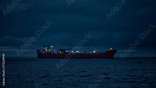 Silhouette of oil tanker in the sea at night.