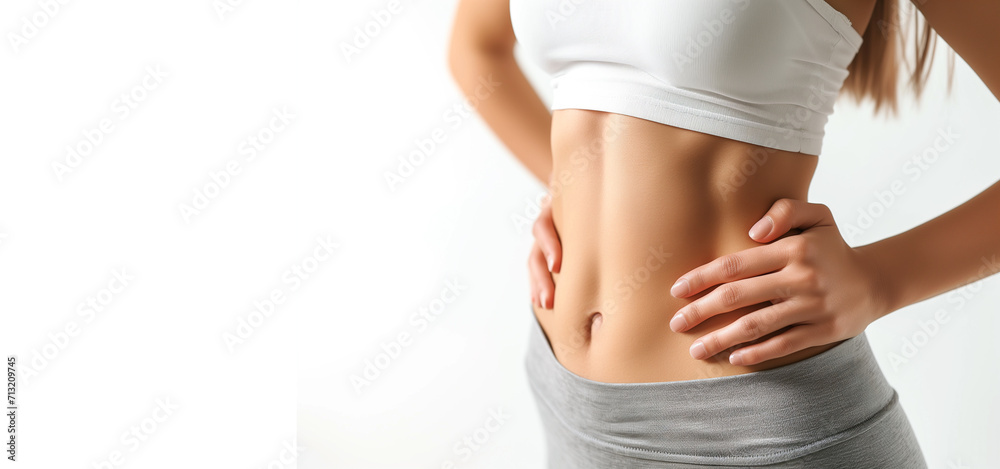 Fototapeta premium Young woman with flat belly white background, closeup. Plastic surgery concept. healthy lifestyle 