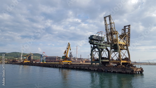 A colossal crane precariously perched atop a vast expanse of water, ready to lift and move heavy loads.