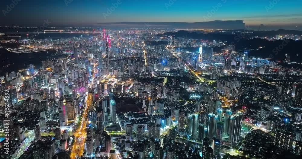 Aerial forward shot of Shenzhen financial district skyline and streets at night Aerial forward shot of Shenzhen financial district skyline and streets at night