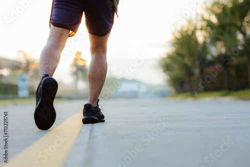 Portrait of a young Asian man in sports clothes jogging in the morning. man running at sunrise health care © Witoon