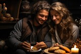 A couple indulges in a cozy indoor snack, the warm candlelight illuminating their content faces as they savor the delicious baked goods before them
