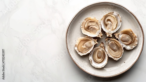 Top view of raw abalone kept on a plate on a white backdrop with a big copy space, Generative AI. photo