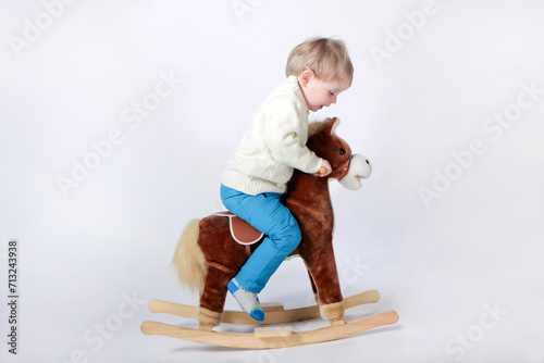 boy on a wooden horse. child rocking horse little boy riding a toy horse, rocking chair children's toy vintage