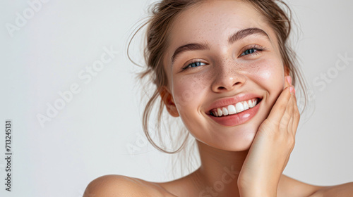 Portrait of beautiful woman with natural make up touching her face. Beauty young woman with fresh clean perfect skin. Skin care concept. Cosmetology, beauty and spa. Facial treatment. Natural skin.