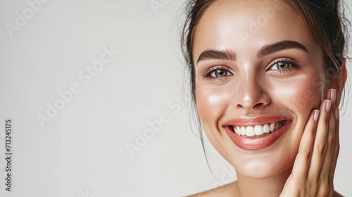 Photographie Portrait of beautiful woman with natural make up touching her face