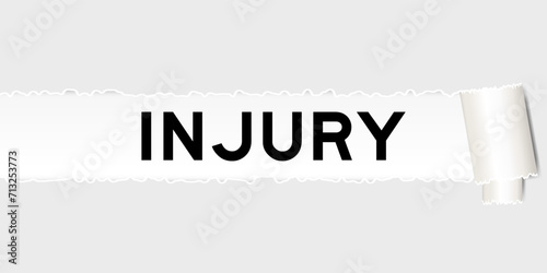 Ripped gray paper background that have word injury under torn part
