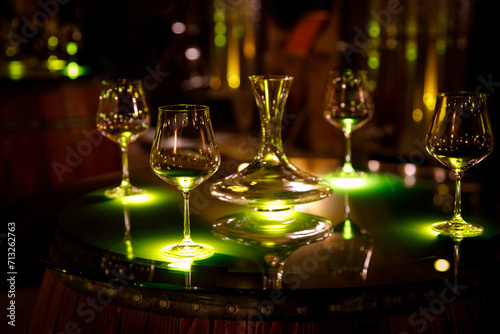 Wine glasses and decanter in a vintage cellar.