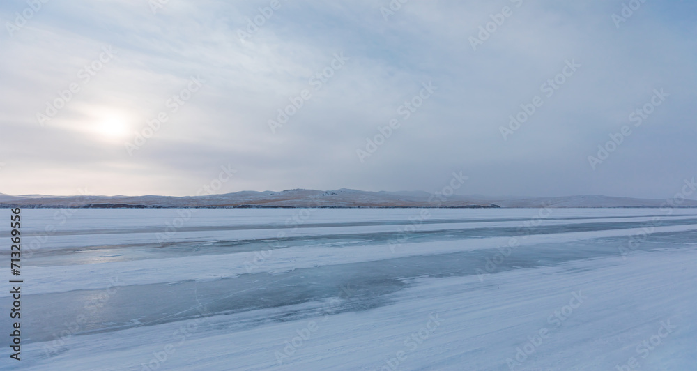 Beautiful winter landscape with car tire tracks (trail) in fresh snow - Baikal Lake, Siberia Beautiful winter landscape with car tire tracks (trail) in fresh snow - Baikal Lake, Siberia