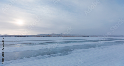 Beautiful winter landscape with car tire tracks  trail  in fresh snow - Baikal Lake  Siberia