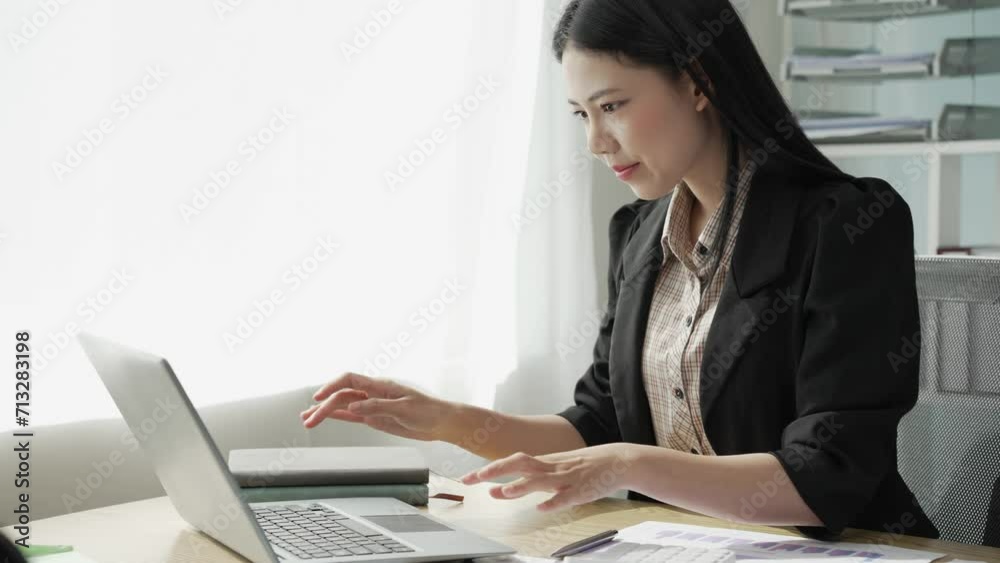 Young Asian business woman doing statistics planning and holding a chart, graph tablet and staff taking notes. Financial statistics success concept, 4k video Young Asian business woman doing statistics planning and holding a chart, graph tablet and staff taking notes. Financial statistics success concept, 4k video