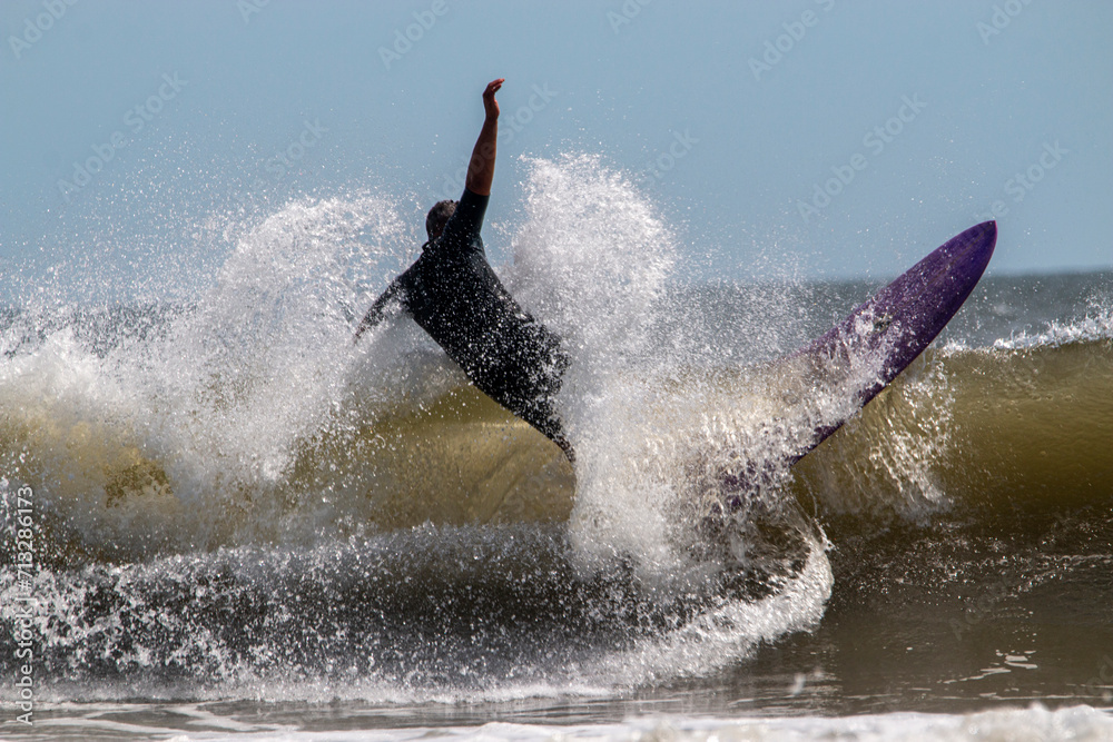Surfer wiping out riding a wave