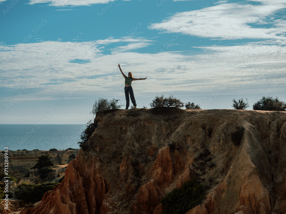 Woman posing in a cliff in portugal