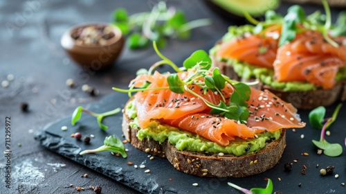 Open sandwiches with salted salmon, guacamole avocado and microgreens. Healthy food photo