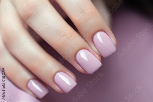 Glamour woman han with one color nail polish on her fingers. French manicure