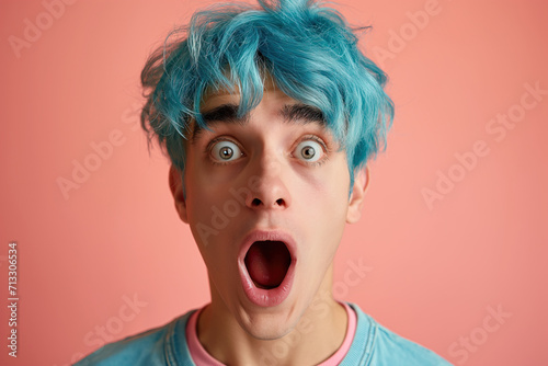 Surprised Young Male with Blue Hair on Peach Background © Ryan