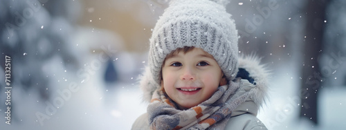 Cute little boy in hat with pompon and scarf. Style concept, happy childhood.