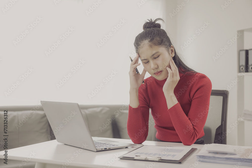 Asian Millennial Businesswoman or Stressed Office Worker Feeling Trying Upset with her performance Depression, feeling anxious and uncomfortable about business sales and have a headache while working Asian Millennial Businesswoman or Stressed Office Worker Feeling Trying Upset with her performance Depression, feeling anxious and uncomfortable about business sales and have a headache while working