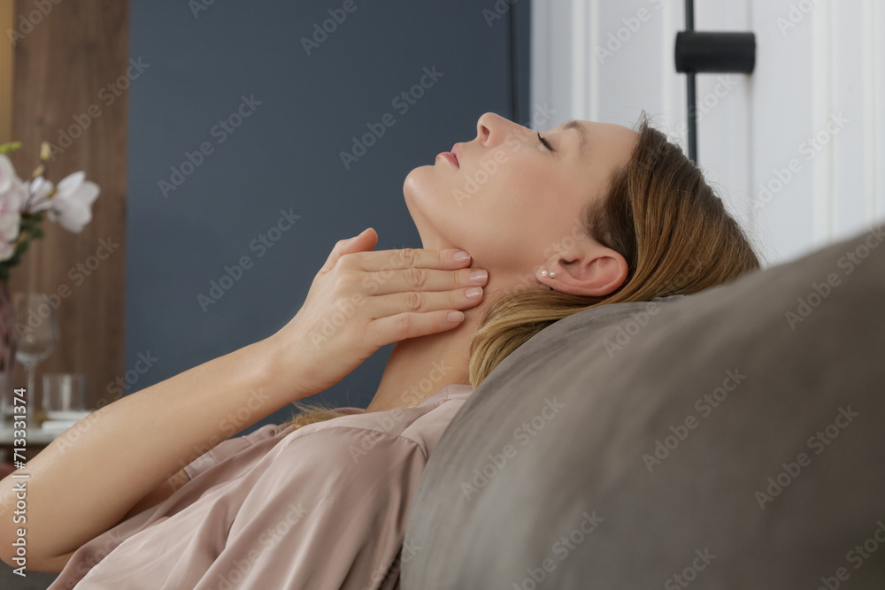 Caucasian woman touching her throat. Sore throat, cold, flu, tonsillitis or thyroid gland problem