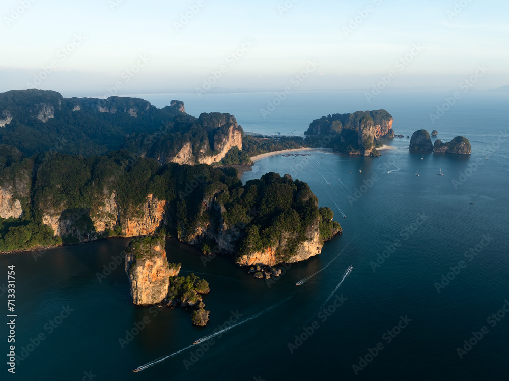 View from above, stunning aerial view of the Ao Nang coast at sunset with the Ao Nang Tower, Tonsai beach and Railay Beach in the distance, Krabi, Thailand.