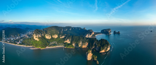 View from above, aerial shot, panoramic view of the Ao Nang coast at sunset with the Ao Nang Tower, Tonsai beach and Railay Beach in the distance, Krabi, Thailand. photo