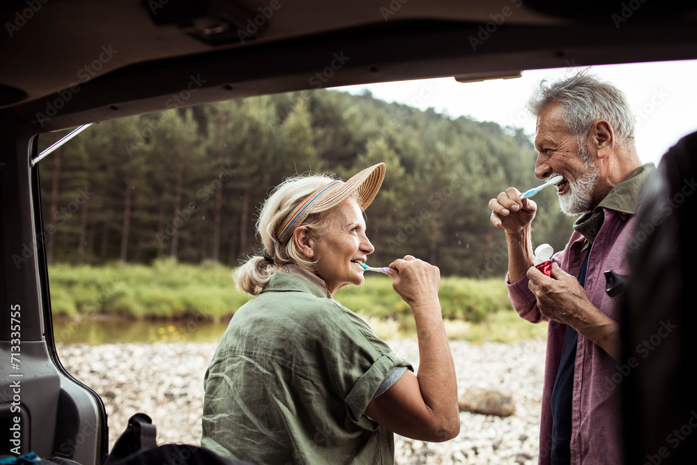 © Marko Geber - Senior couple brushing teeth on camping trip © Marko Geber - Senior couple brushing teeth on camping trip